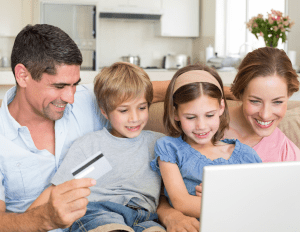 Parents purchasing items on tech device with their Generation Alpha Children 