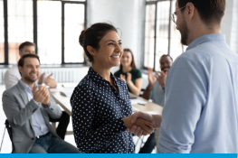 woman shaking bosses hand and smiling