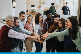 A group of people with their hands in the centre